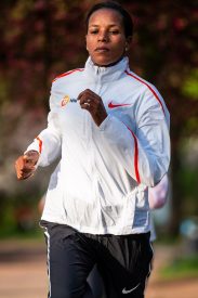 Mimi Belete Carrying Bahrain’s Flag into Scotiabank Toronto Waterfront Marathon